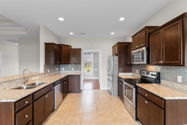 4067 Ridgewood Dr, Conway, SC 29526 - kitchen featuring stainless steel appliances, a sink, a peninsula, tasteful backsplash, and light stone counters