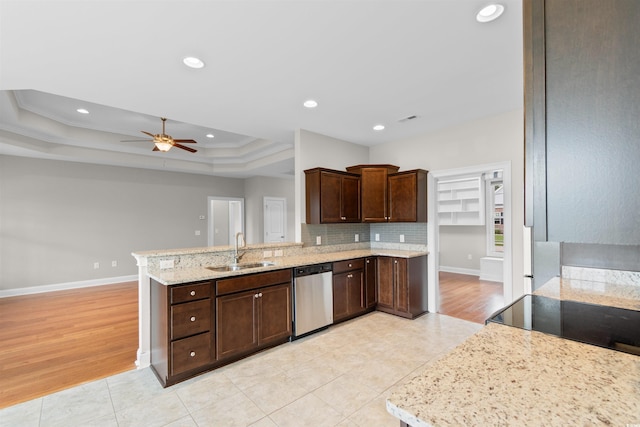 4067 Ridgewood Dr, Conway, SC 29526 - kitchen with dishwasher, a sink, a peninsula, dark brown cabinets, and a raised ceiling