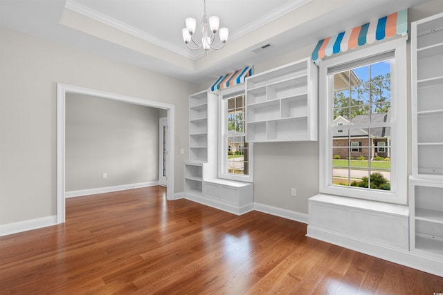 4067 Ridgewood Dr, Conway, SC 29526 - unfurnished dining area featuring ornamental molding, a chandelier, built in features, wood finished floors, and baseboards