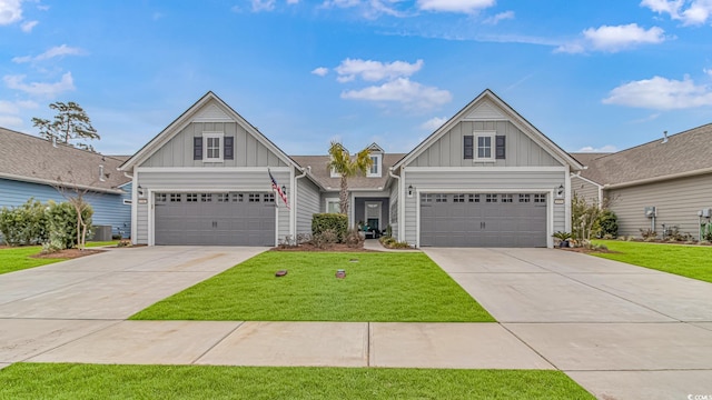 craftsman house with board and batten siding, a front yard, and driveway
