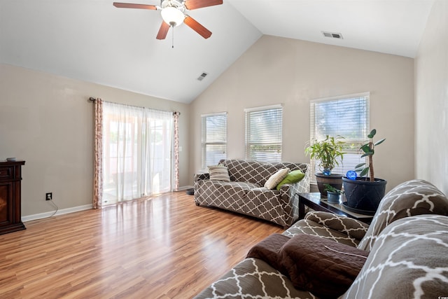 living room featuring ceiling fan, healthy amount of natural light, light wood finished floors, high vaulted ceiling, and baseboards
