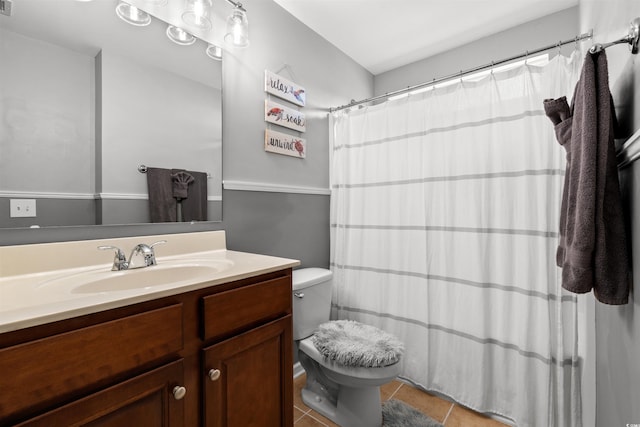 full bath featuring tile patterned flooring, vanity, toilet, and curtained shower