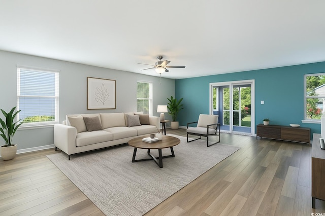 living room with wood finished floors, baseboards, and a ceiling fan