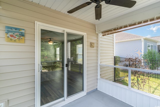unfurnished sunroom with ceiling fan