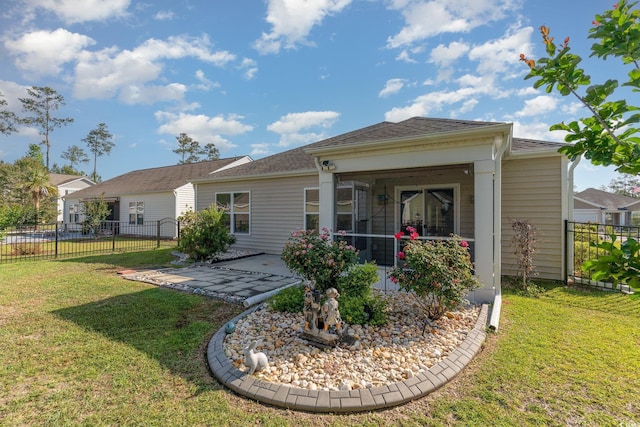 back of property with a yard, fence, and a patio