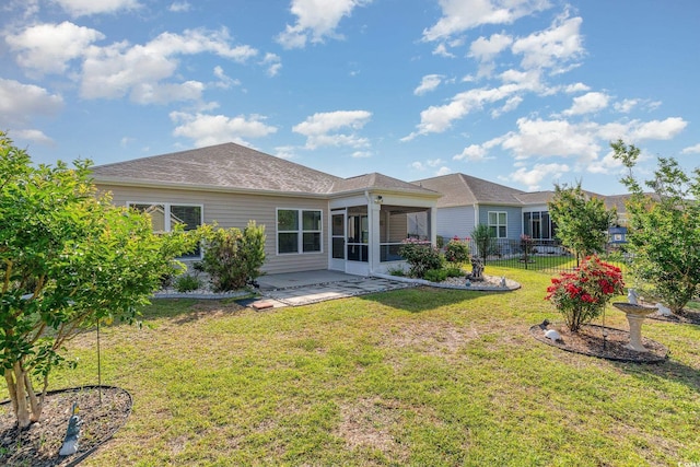 rear view of property with a sunroom and a patio