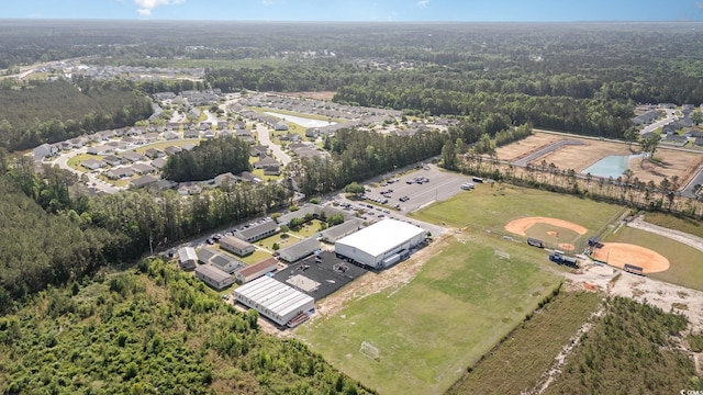 aerial view of property and surrounding area with a forest