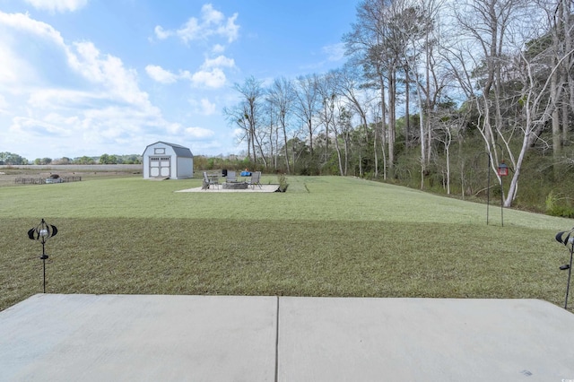 250 Ole Maple St, Loris, SC 29569 - view of grassy yard with a storage unit, an outdoor structure, a patio area, and an outdoor fire pit
