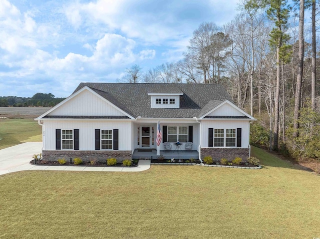 250 Ole Maple St, Loris, SC 29569 - modern farmhouse style home featuring covered porch, a front yard, brick siding, and a shingled roof