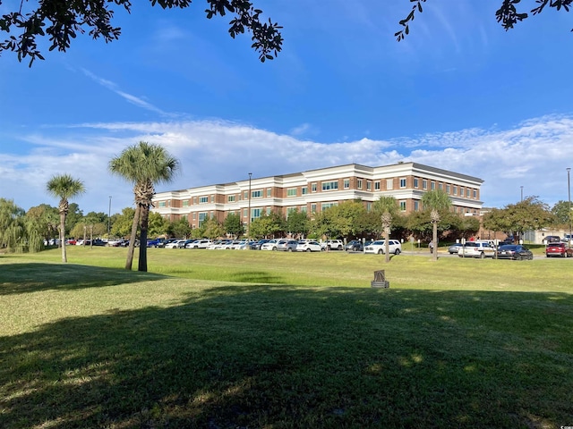 view of property's community with a lawn