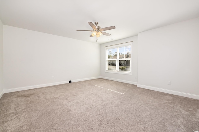 unfurnished room with baseboards, carpet, and a ceiling fan