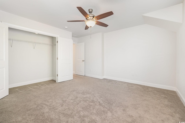 unfurnished bedroom featuring carpet, a closet, ceiling fan, and baseboards
