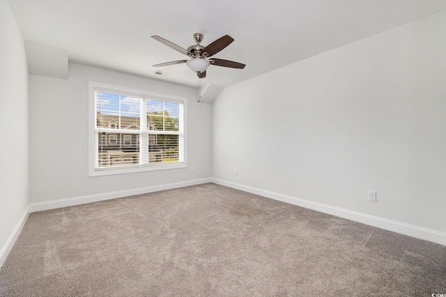 carpeted spare room with baseboards and a ceiling fan