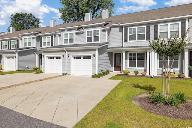 multi unit property with driveway, an attached garage, a front yard, and a chimney