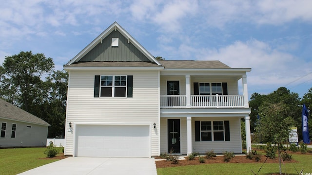 733 Choctaw Dr, Conway, SC 29526 - view of front of house with covered porch, a balcony, driveway, a garage, and board and batten siding