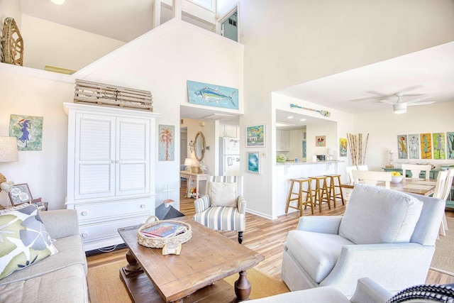 124 Spartina Ct Unit 30, Pawleys Island, SC 29585 - living room with light wood-style floors, a ceiling fan, and a high ceiling