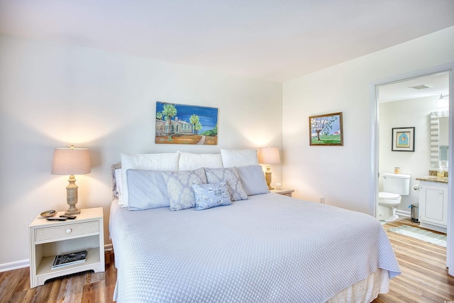 124 Spartina Ct Unit 30, Pawleys Island, SC 29585 - bedroom with wood finished floors and ensuite bath