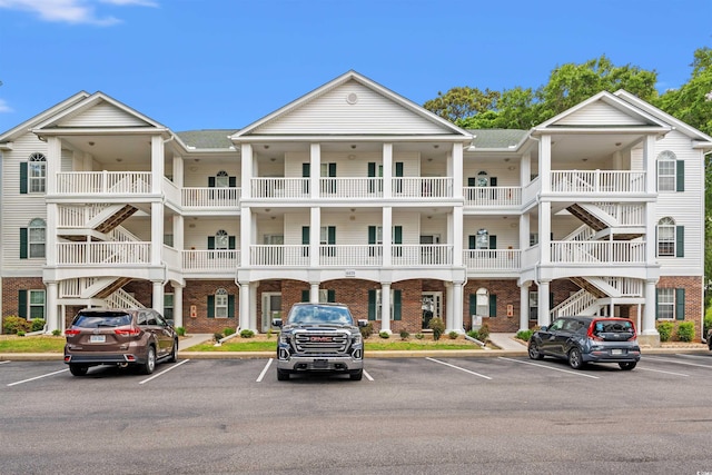 4429 Turtle Ln Unit 3A, Little River, SC 29566 - view of property with stairs and uncovered parking