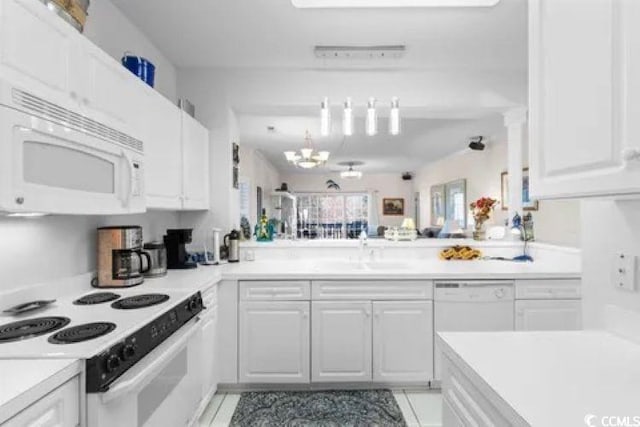 4429 Turtle Ln Unit 3A, Little River, SC 29566 - kitchen featuring white appliances, white cabinets, a sink, light countertops, and a chandelier