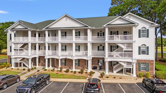 4429 Turtle Ln Unit 3A, Little River, SC 29566 - view of property featuring stairway and uncovered parking