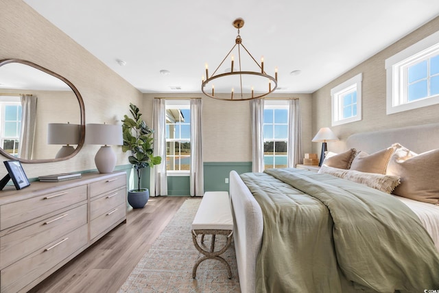 402 Sun Colony Blvd, Longs, SC 29568 - bedroom with a chandelier, light wood-style flooring, and wallpapered walls