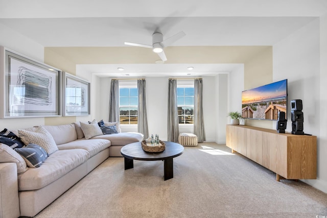 living room with light colored carpet and ceiling fan