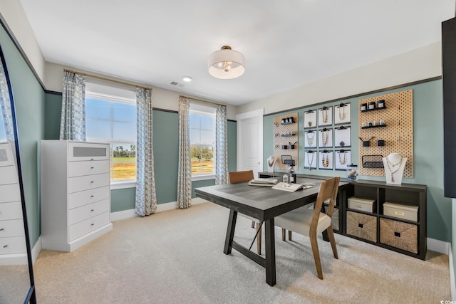 carpeted office with baseboards and visible vents