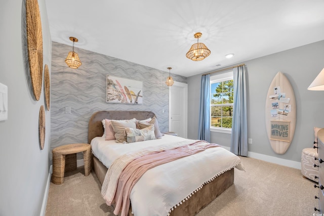 bedroom with wallpapered walls, baseboards, carpet floors, and an accent wall