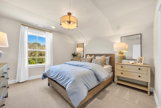 bedroom featuring light colored carpet, visible vents, baseboards, and lofted ceiling
