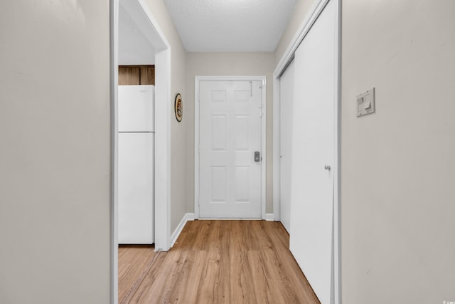 6612 Wintergreen Pt, Myrtle Beach, SC 29588 - corridor with a textured ceiling, baseboards, and light wood-style floors