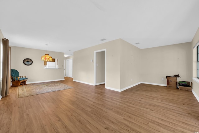 6612 Wintergreen Pt, Myrtle Beach, SC 29588 - unfurnished living room with light wood-type flooring and baseboards
