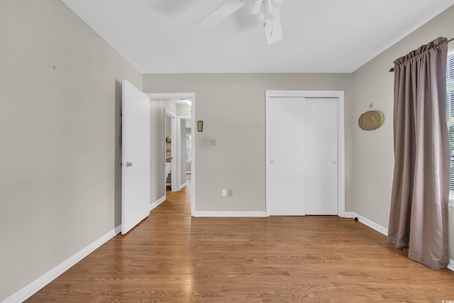 6612 Wintergreen Pt, Myrtle Beach, SC 29588 - unfurnished bedroom featuring light wood finished floors, a closet, baseboards, and ceiling fan