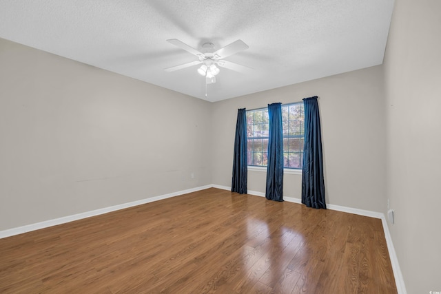 6612 Wintergreen Pt, Myrtle Beach, SC 29588 - spare room with a textured ceiling, ceiling fan, wood finished floors, and baseboards