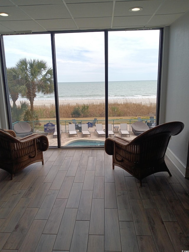 2207 S Ocean Blvd Unit 1407, Myrtle Beach, SC 29577 - sunroom with a beach view, a water view, wood finished floors, floor to ceiling windows, and recessed lighting