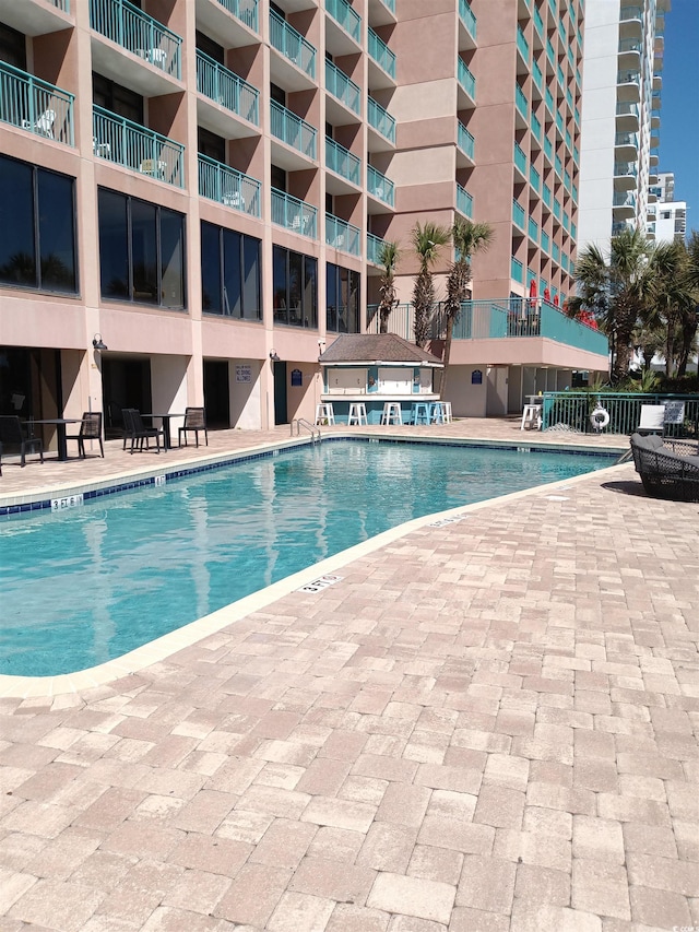 2207 S Ocean Blvd Unit 1407, Myrtle Beach, SC 29577 - community pool featuring a patio area and fence