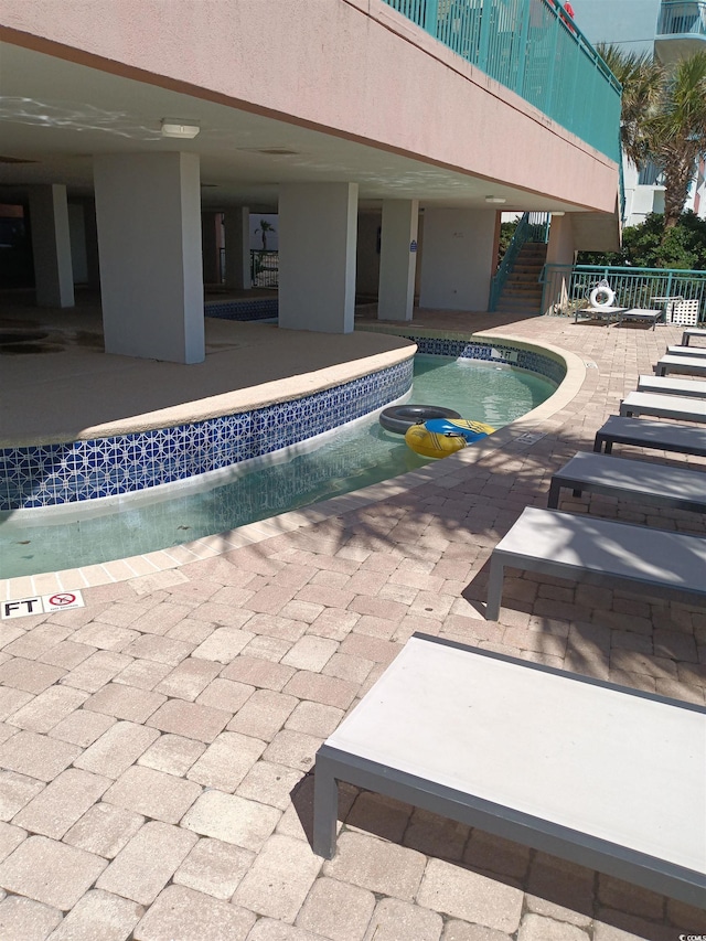 2207 S Ocean Blvd Unit 1407, Myrtle Beach, SC 29577 - community pool featuring stairway, a patio, and a jacuzzi