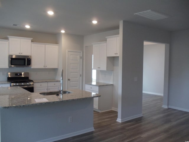 8719 Baton Rouge Ave NW, Calabash, NC 28467 - kitchen featuring stainless steel appliances, a sink, light stone counters, decorative backsplash, and recessed lighting