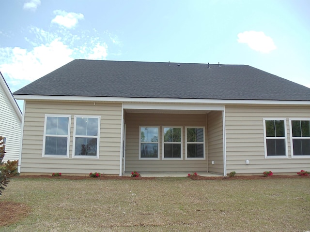 8719 Baton Rouge Ave NW, Calabash, NC 28467 - rear view of property featuring a yard
