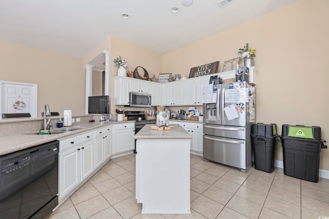 kitchen featuring a sink, stainless steel appliances, white cabinetry, light countertops, and a kitchen island