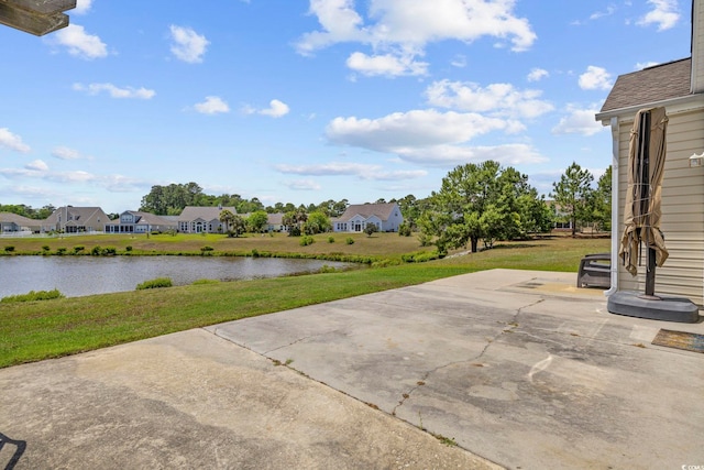 view of patio / terrace with a water view and a residential view