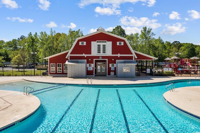 pool with fence and a patio