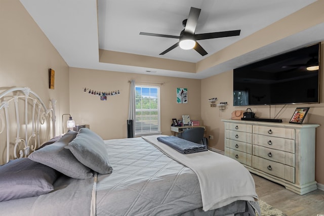 101 Alpharetta Ct, Conway, SC 29526 - bedroom with a raised ceiling, light wood-style floors, and a ceiling fan