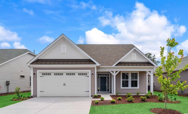 view of front facade featuring board and batten siding, a standing seam roof, driveway, a garage, and roof with shingles