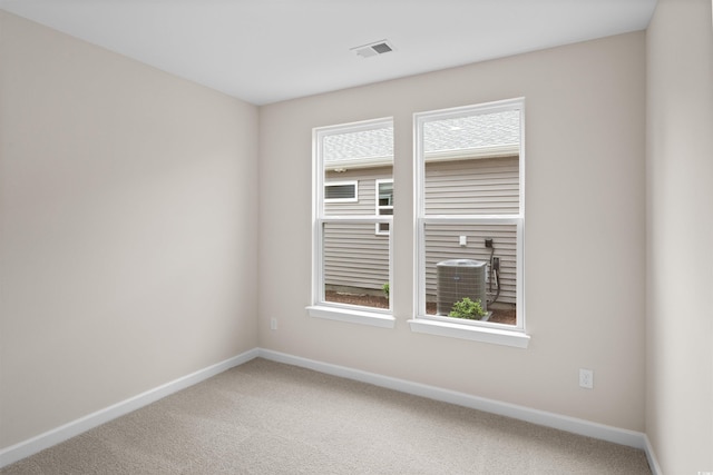 carpeted spare room featuring baseboards