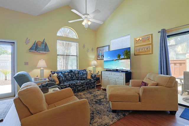 living area with dark wood-style flooring, ceiling fan, and high vaulted ceiling
