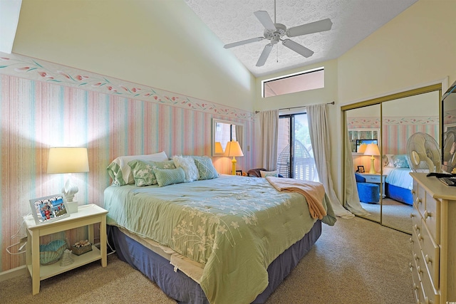 carpeted bedroom with high vaulted ceiling, a textured ceiling, a closet, and a ceiling fan