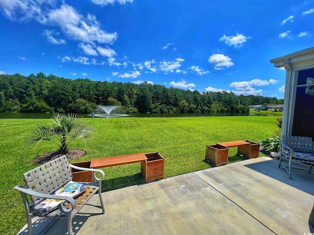 view of patio / terrace with a water view and a forest view
