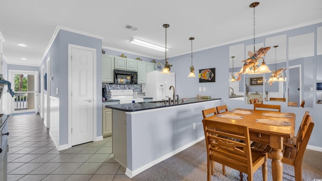 kitchen with white appliances, visible vents, a sink, crown molding, and backsplash