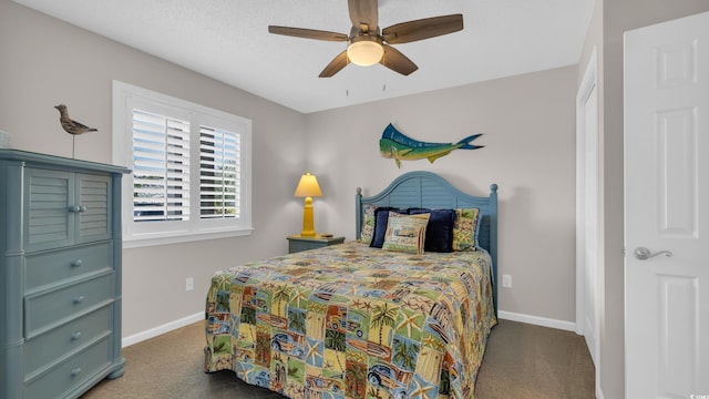bedroom with ceiling fan, carpet floors, and baseboards