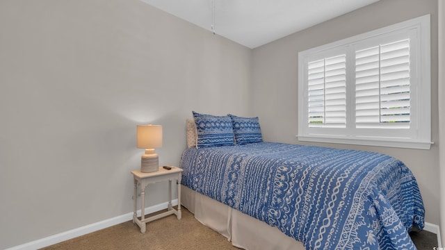 bedroom with carpet and baseboards